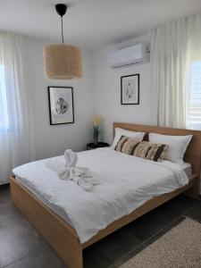 a bedroom with a large bed with a bow on it at view point relax in Eilat