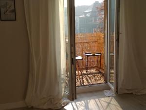 a sliding glass door to a balcony with a view at Kawalerka w Centrum Kalisza in Kalisz +6 photos
