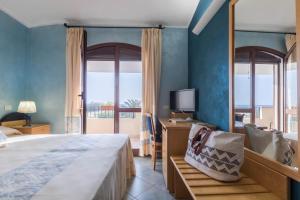Postel nebo postele na pokoji v ubytování Hotel Villa del Mare Solanas