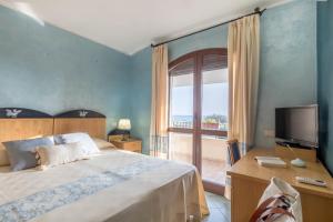 Postel nebo postele na pokoji v ubytování Hotel Villa del Mare Solanas