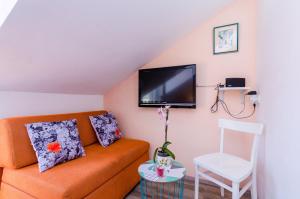 a living room with a couch and a chair at Guest House Avdic in Dubrovnik