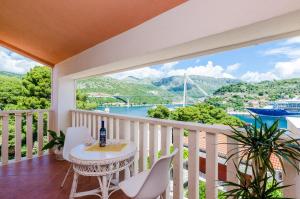 a balcony with a table and chairs and a view of the water at Guest House Avdic in Dubrovnik