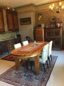 a dining room with a wooden table and chairs at Remuganes suite - Porvoon Linna in Porvoo +20 photos