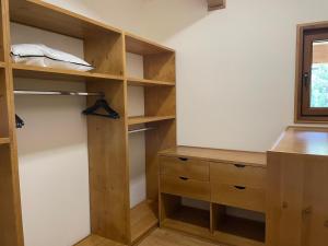 a closet with wooden shelves and a window at Villa Naya, Pirin Golf & Spa in Bansko