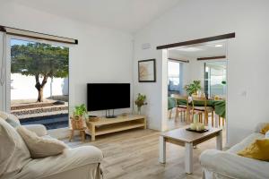 uma sala de estar com televisão e uma sala de jantar em Los Cipreses em Ingenio