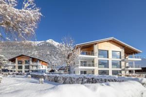 aominium building in the snow with mountains in the background at EuroParcs Hermagor - Nassfeld in Hermagor