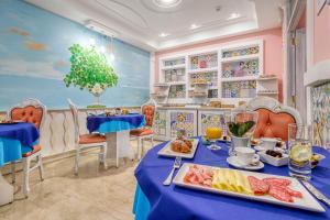a dining room with a table with food on it at Hotel Prestige in Sorrento