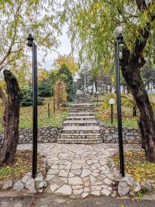 a stone path with two lights in a park at Bahus Inn in Belgrade