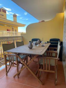 d'une table et de chaises en bois sur un balcon. dans l'établissement Santa Lovers, à Santa Cruz