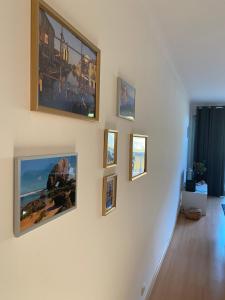 a hallway with several pictures on the wall at Santa Lovers in Santa Cruz