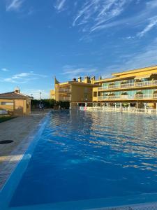 a swimming pool in front of a hotel at Santa Lovers in Santa Cruz