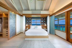 a bedroom with a bed and a view of the ocean at OBLU SELECT Lobigili - Premium All-Inclusive with Free Transfers in Male City