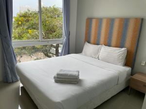 Postel nebo postele na pokoji v ubytování Atlantis Condo Resort jomtien