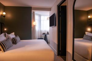 Cama ou camas em um quarto em Le Celtique & Spa