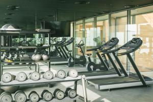 a gym with a bunch of treadms and weights at SHIRVAN Hotel City Yard Jeddah in Jeddah