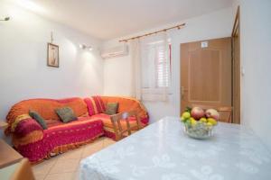 a living room with a couch and a table at Apartments Longo in Supetar