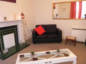 a living room filled with furniture and a fire place at The Weston Super Mare Guest House in Weston-super-Mare