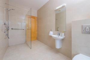 a bathroom with a shower and a sink and a toilet at Park Place Apartments in Killarney +16 photos
