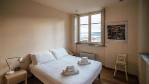 a bedroom with a bed with two towels on it at Virgilio 2 - Villa Bice in Alassio