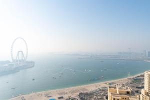 an aerial view of a beach and a ferris wheel at LiveIn Holiday Homes - JBR in Dubai