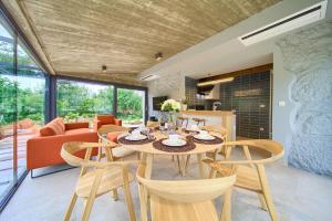 a dining room and living room with a table and chairs at Luxury Jerini Barn in Krk