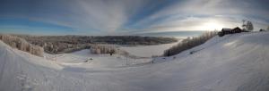 a ski slope with people skiing down a snow covered slope at Malskaya Dolina in Rogovo