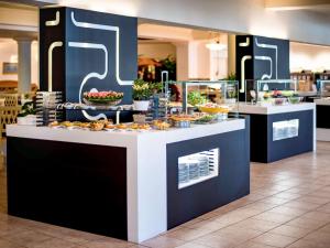 a buffet line with food on display in a restaurant at Almar Timi Ama Resort & Spa in Villasimius