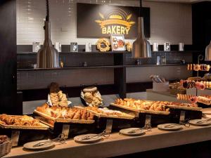 a bakery with many different types of pastries on display at Almar Timi Ama Resort & Spa in Villasimius