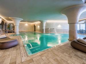 a swimming pool in a hotel with a pool at Almar Timi Ama Resort & Spa in Villasimius