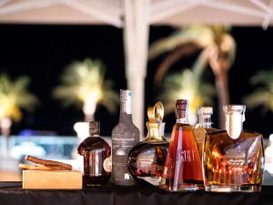 a group of bottles of alcohol sitting on a table at Almar Timi Ama Resort & Spa in Villasimius