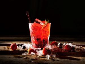 a drink with strawberries and ice on a table at Almar Timi Ama Resort & Spa in Villasimius