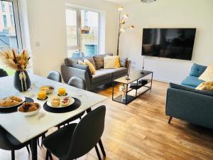 een woonkamer met een tafel met eten erop bij Stylish New Build with Garden and Free Parking in Taunton