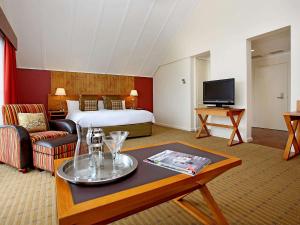 a hotel room with a bed and a coffee table at Fairmont Resort & Spa Blue Mountains MGallery by Sofitel in Leura