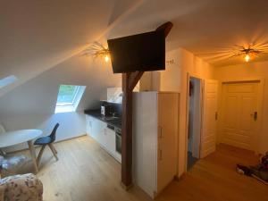 a room with a kitchen with a refrigerator and a table at Forsthaus in Crimmitschau