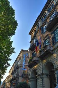 a building with a sign on the side of it at Best Western Hotel Genio in Turin