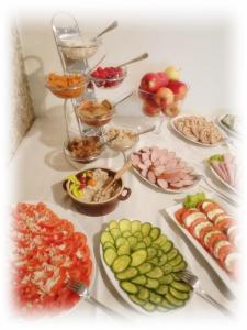 a table full of different types of food on plates at Hotel TiM in Cekanowo +40 photos