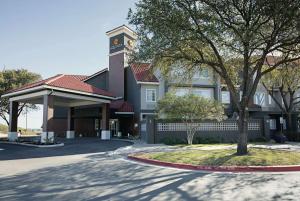 a building with a clock tower on top of it at La Quinta by Wyndham Austin at The Domain in Austin