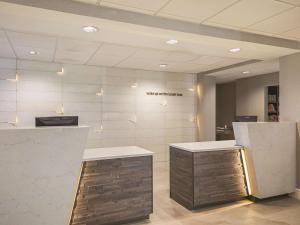 a lobby with a counter and a wall withcriptions on it at La Quinta by Wyndham Austin at The Domain in Austin