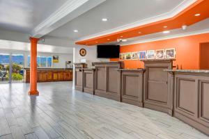 a large room with orange walls and wooden cabinets at Motel 6-Ukiah, CA - North in Ukiah