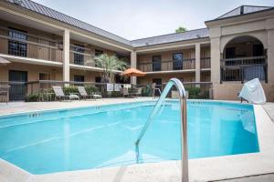 a swimming pool in front of a hotel at Clarion Inn & Suites in Aiken
