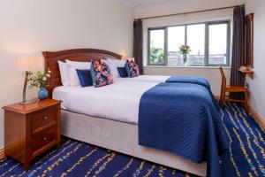 a bedroom with a large bed and a window at Park Place Apartments in Killarney