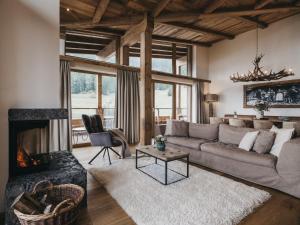 a living room with a couch and a fireplace at VAYA St Zeno Serfaus in Serfaus