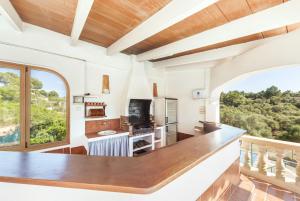 a kitchen with a large counter and a large window at Rustica s'Aranjassa in Palma de Mallorca