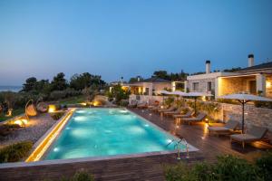 una piscina con muebles de exterior y una casa en Elies Residences en Mitilene