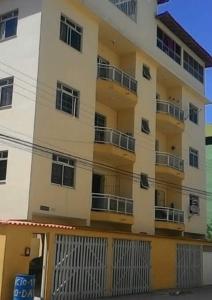 a tall building with balconies on the side of it at Apartamento Piúma in Piúma