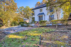 a house with leaves on the grass in front of it at Edgewater Estate - 5 Bdrm Sleeps 10 - Near It All in Atlanta