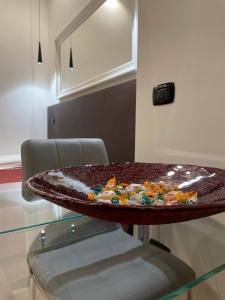 a table with a bowl of candy on top of it at Elian Apartament In The Center of Rome in Rome