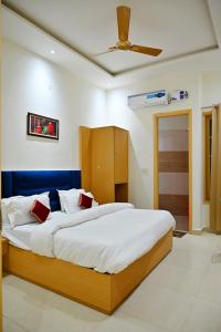 a bedroom with a large bed and a ceiling fan at KOZZY B&B in Amritsar