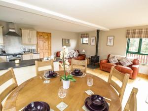 a kitchen and living room with a wooden table and chairs at 12 Cornadarragh in Belturbet