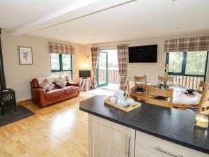 a kitchen and living room with a couch and a table at 12 Cornadarragh in Belturbet
